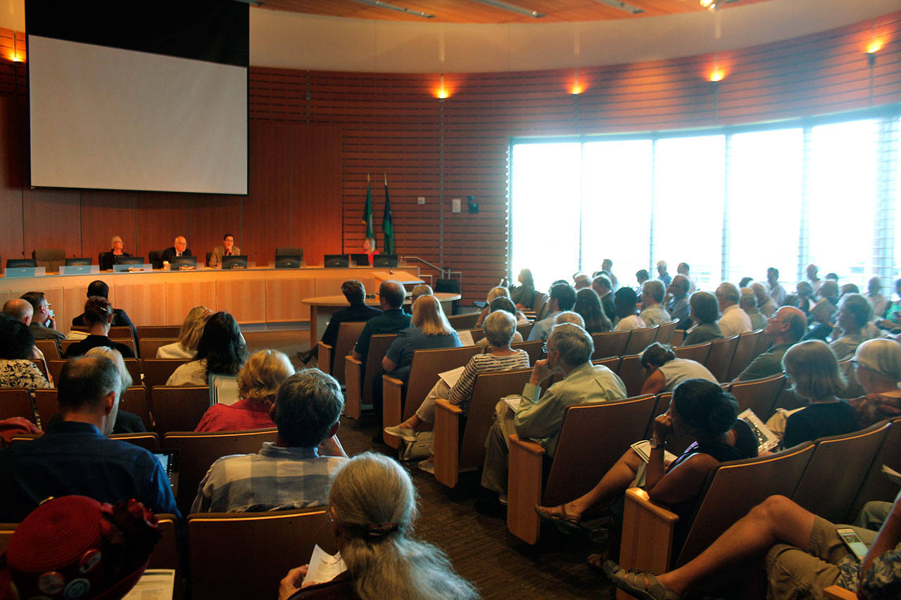 Residents countywide and environmental groups filled Bellevue City Hall’s council chambers on Monday during a public hearing for Puget Sound Energy’s rate case before the Washington State Utilities and Transportation Commission. Raechel Dawson/staff photo