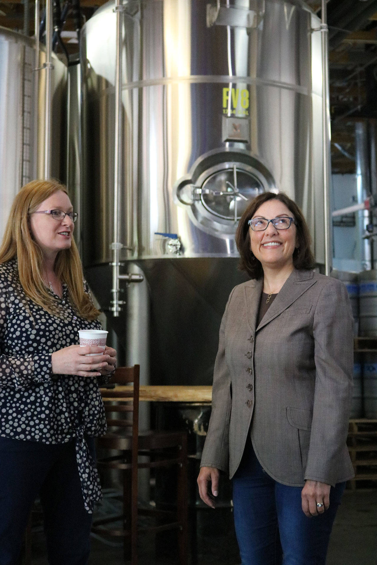 Congresswoman Suzan DelBene, right, tours the Postdoc Brewing facility in Redmond with co-owner Debbie Chambers on Tuesday. Andy Nystrom, Redmond Reporter
