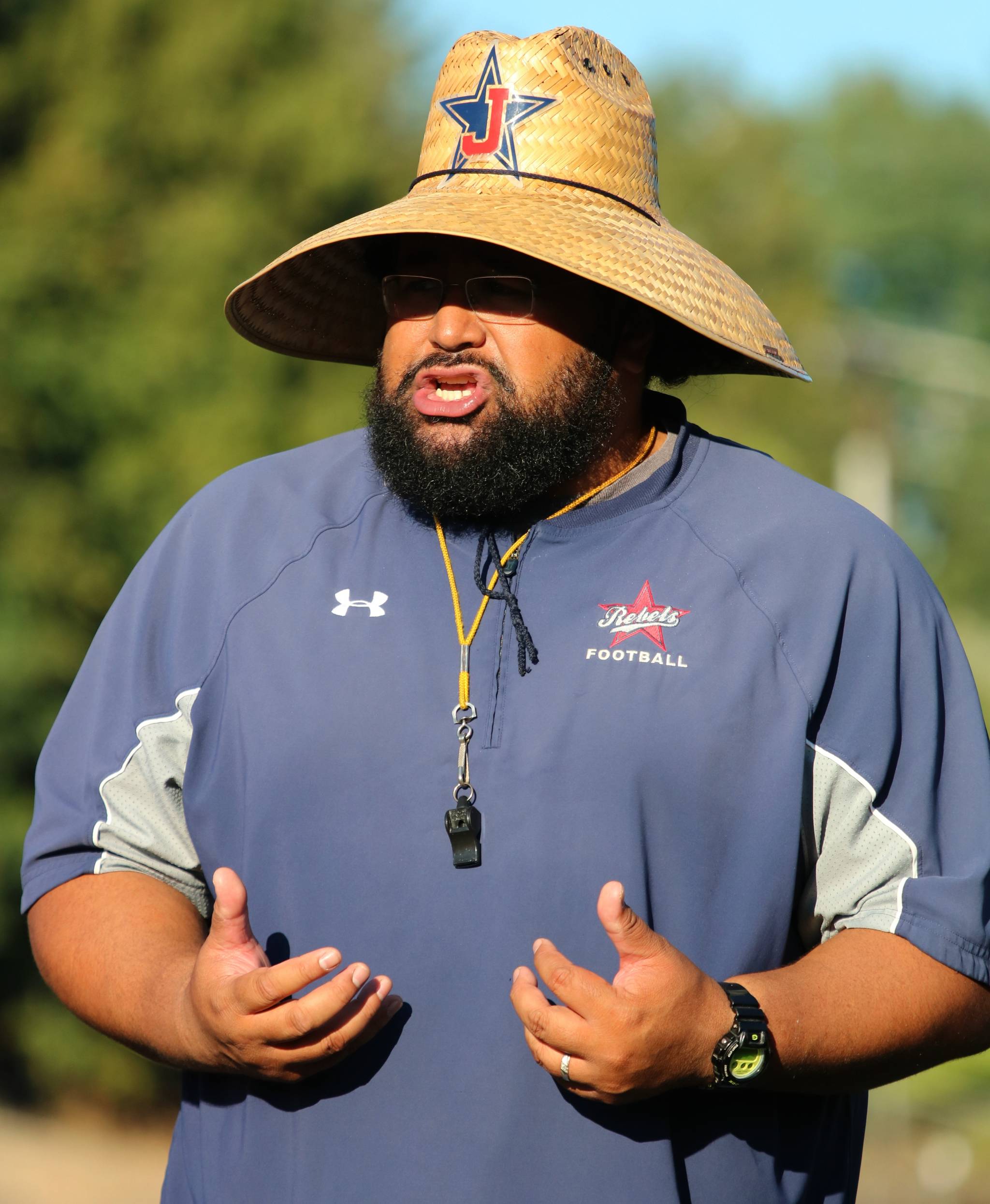 Juanita High head coach Lele Te’o encourages his players during a recent practice. Andy Nystrom, Kirkland Reporter