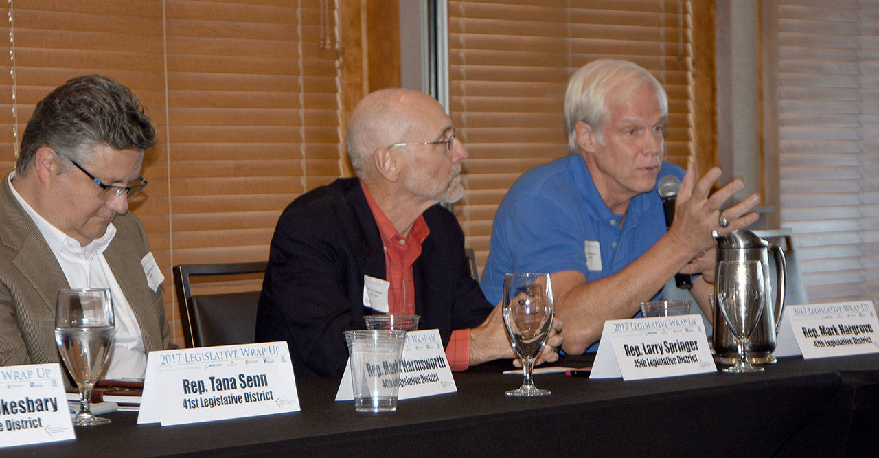 Rep. Mark Hargrove discusses traffic congestion at a legislative wrap-up session Sept. 14 as Rep. Larry Springer of Kirkland listens. Carol Ladwig, Reporter Newspapers