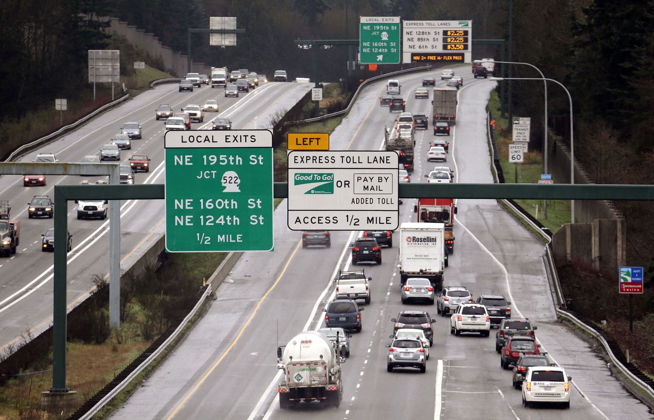 Signs on southbound Interstate 405 give information on the tolls for using express lanes Tuesday, Feb. 16, 2016, in Bothell, Wash. Gov. (AP Photo/Elaine Thompson)