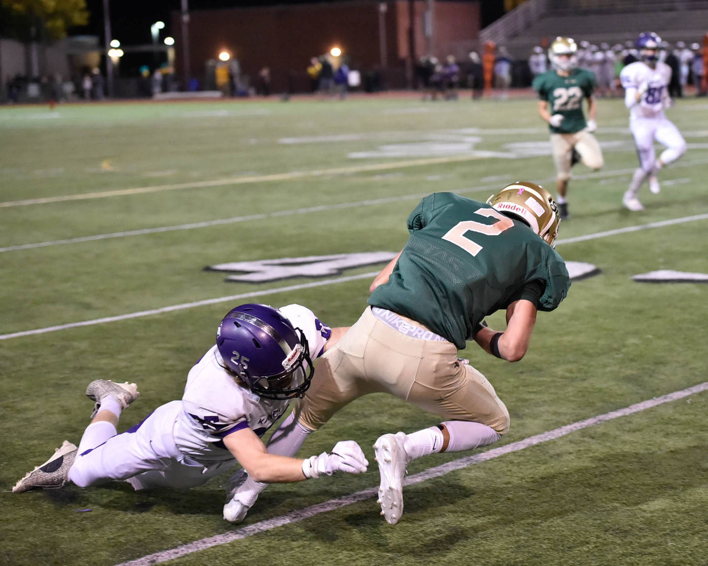 Lake Washington’s Brayden Boyes, left, grabs Redmond’s Bradley Cagle during Friday’s game. Courtesy of Marc La Pierre Photography http://marclapierre.photodeck.com/