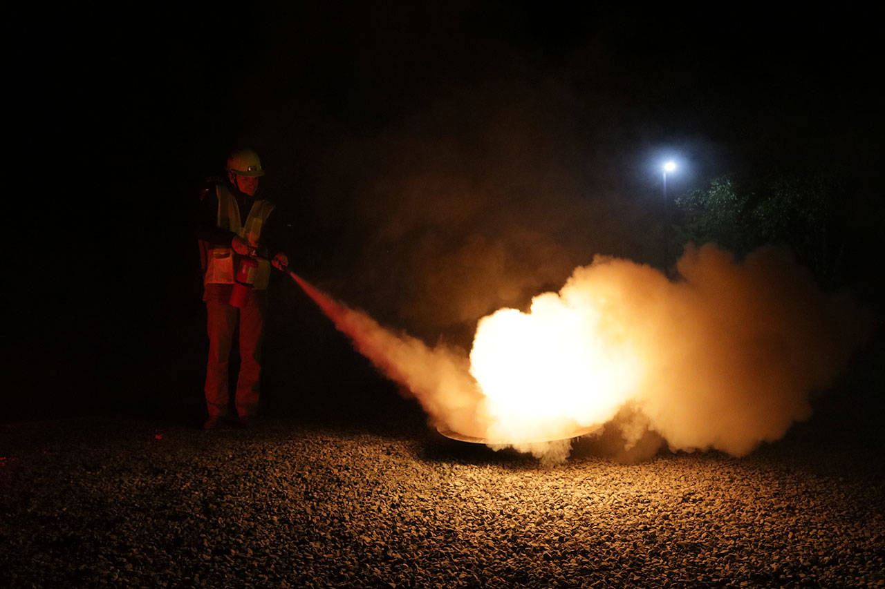 Matthew Horine puts out a fire during a CERT training in Kirkland. Megan Campbell/Kirkland Reporter