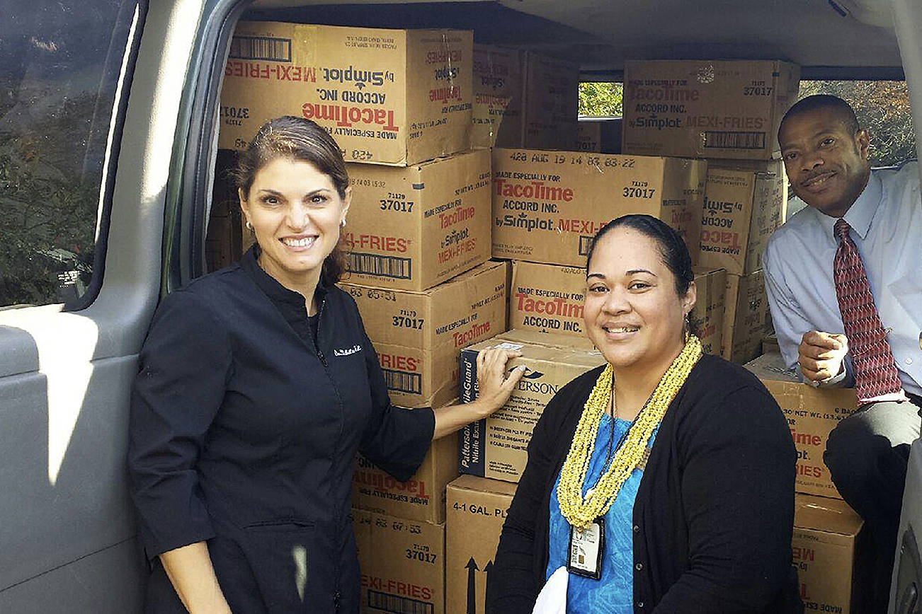 Dr. Michelle Neal loads a car with donations alongside two staff members who collected the donations during the 2015 Candy Buy-back program. Courtesy of Neal Smiles Orthodontics.