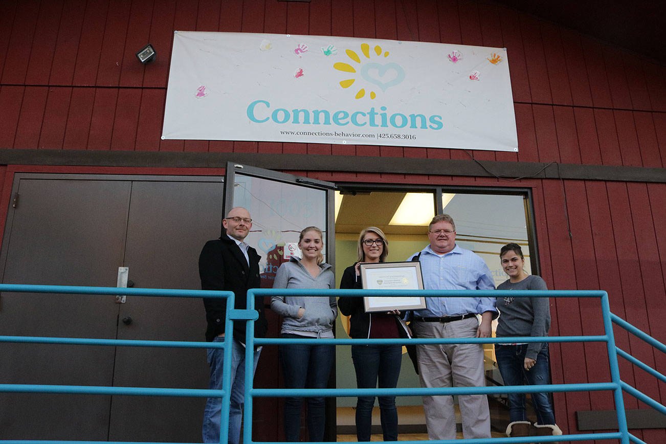 Co-founders James Kidwell and Paul Mullan pose with their staff as they present their BHCOE accreditation certificate. BHCOE accreditation puts Connections Behavior Planning & Intervention in the top 10 percent of ABA therapy providers, according to Mullan.