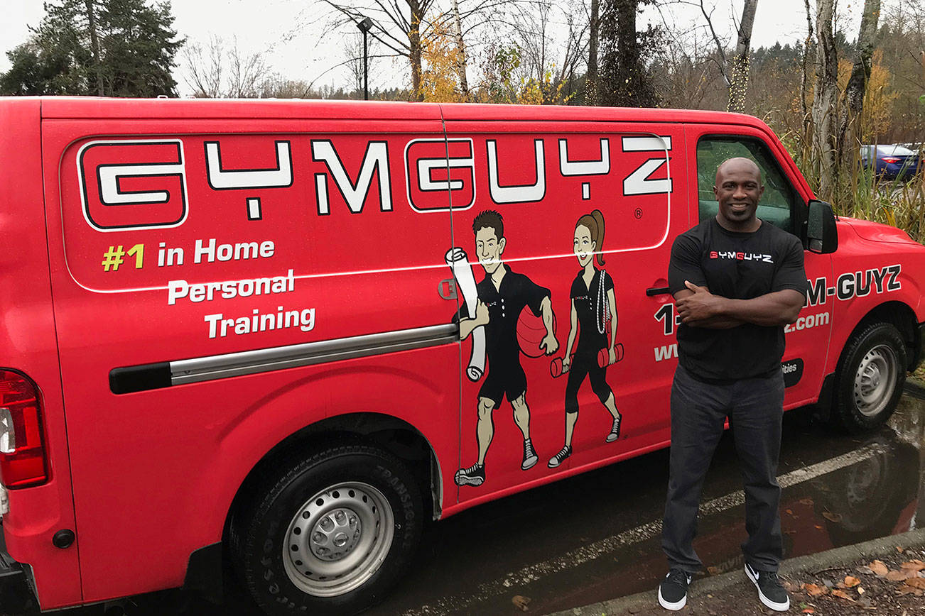 Stacy Edwards, owner of the Eastside GYMGUYZ franchise, opens his van to show the various equipment his trainers use with their clients. Kailan Manandic, Kirkland Reporter