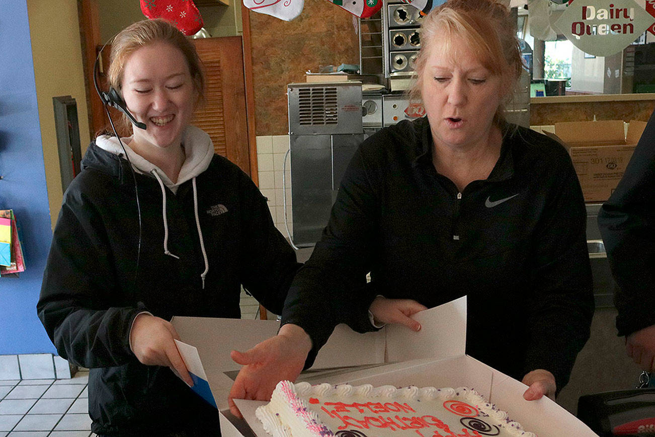 Kristine Ott alongside her daughter, Kalie, boxes the final cake sold at the Bridle Trails Dairy Queen. Kailan Manandic, Kirkland Reporter