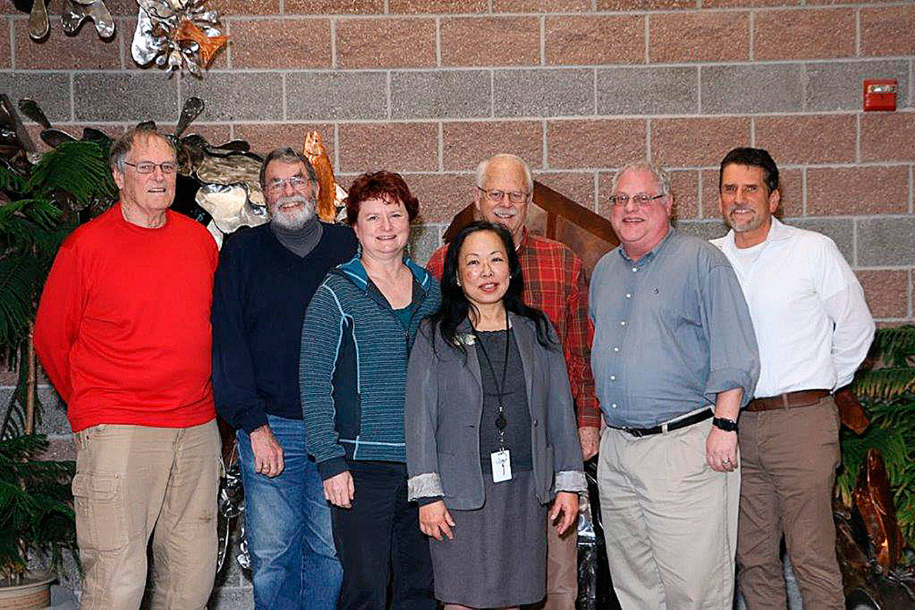 Fanny Yee (center) stands among the Northshore Utility District Board of Commissioners along with Al Nelson (right), who is the incoming general manager. Courtesy of the Northshore Utility District