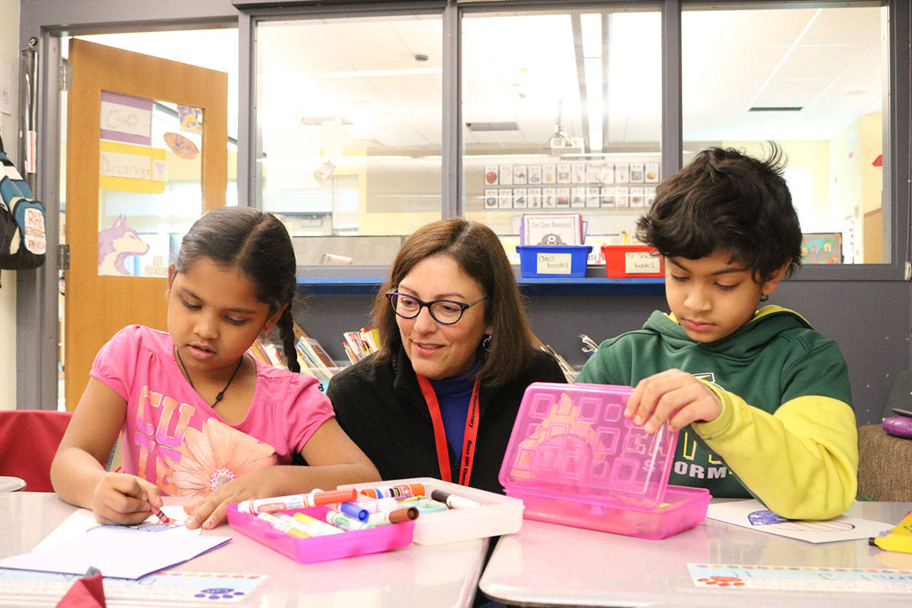 Rep. Suzan DelBene (WA-1) (center) discuss Valentines and veterans with first graders, from left, Diya Karimilla and Namit Jose at Rose Hill Elementary School. Samantha Pak, Kirkland Reporter