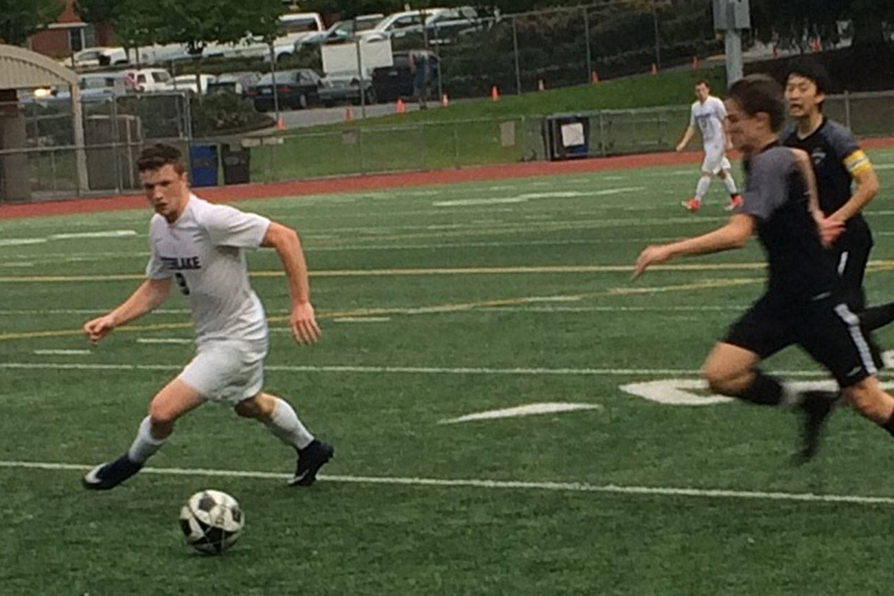 Shaun Scott, staff photo                                Interlake Saints midfielder James Sullivan, left, tries to get to the ball before a Lake Washington player in the first half of a loser-out, KingCo 3A playoff game. Interlake defeated Lake Washington 4-1 on May 8 at Interlake High School in Bellevue.