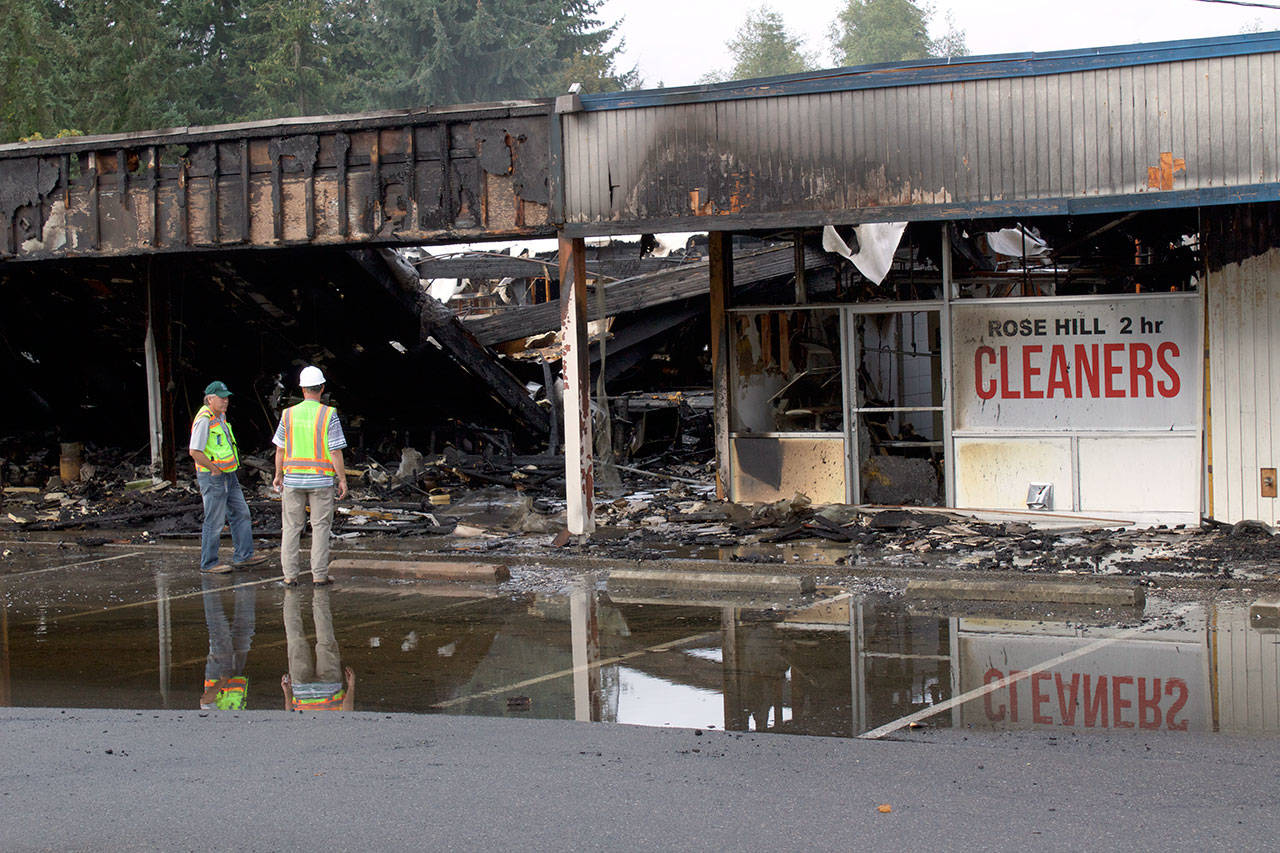 Kirkland firefighters and Puget Sound Energy staff examine the aftermath of a four-hour fire that destroyed the Rose Hill Village and “annihilated” Decks and Spas. Kailan Manandic/staff photo