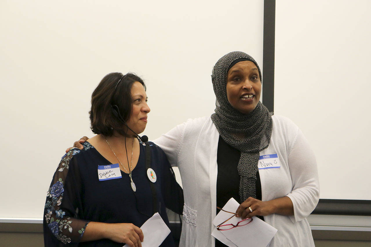 Organizers Debbie Lacy and Nura Adam give a brief speech about the purpose of Welcoming Week before the question and answer discussions begin. Evan Pappas/Staff Photo