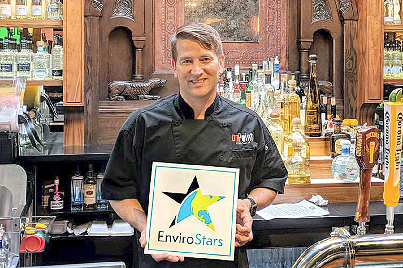 Bret Chatalas, co-owner of Cactus Restaurants, receives the EnviroStar certificate of recognition. Cactus’s six locations are all working toward following environmentally-friendly practices. Photo courtesy of Kirkland Conserves Facebook.