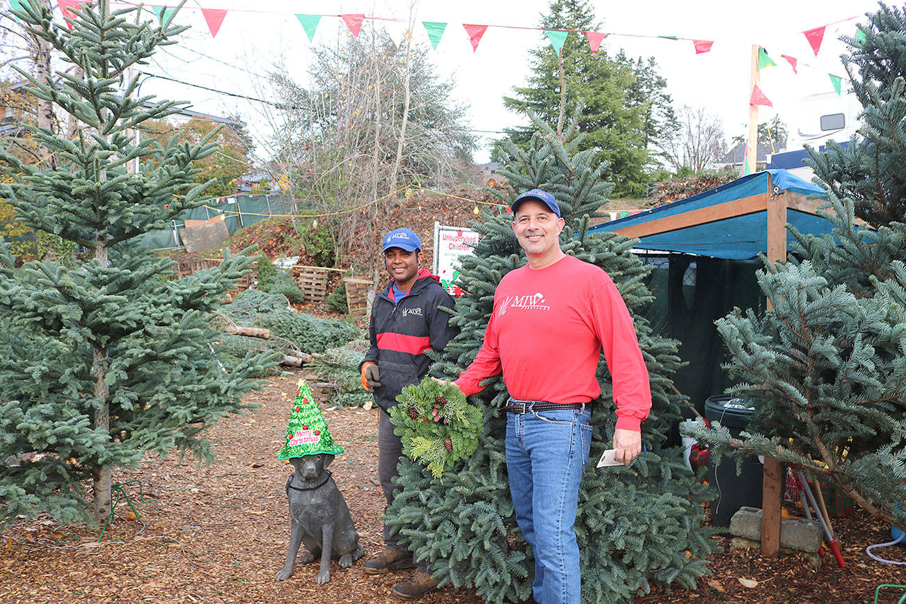 Carmelo Ramirez (left) and owner, Mike Wehrle receive customers in their Kirkland lot on 1006 Lake St. S . Stephanie Quiroz/staff photo