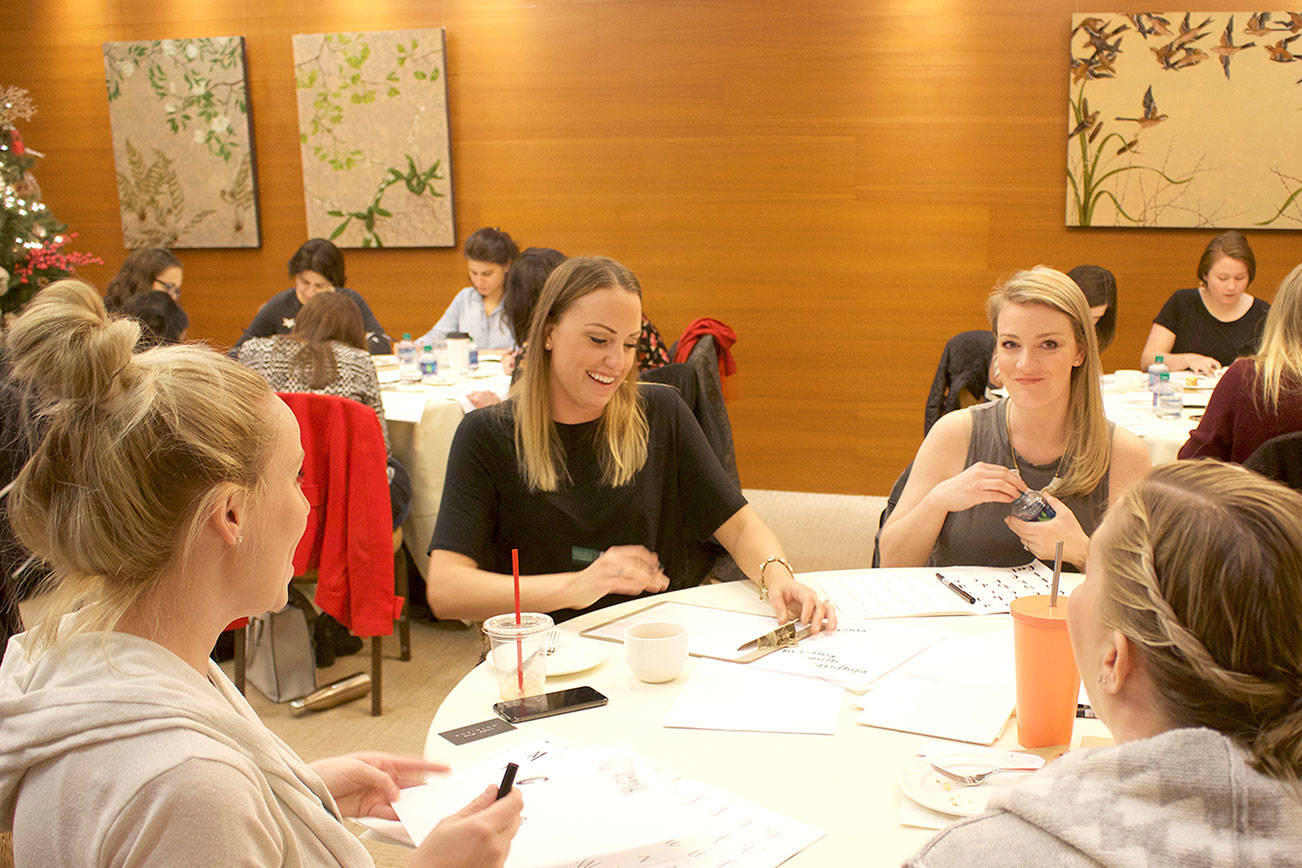 Attendees at a hand lettering class at The Heathman Hotel in Kirkland on Dec. 9, taught by Camille Robinson of Robinson Paperie, practice their newly acquired skills. Stephanie Quiroz/staff photo