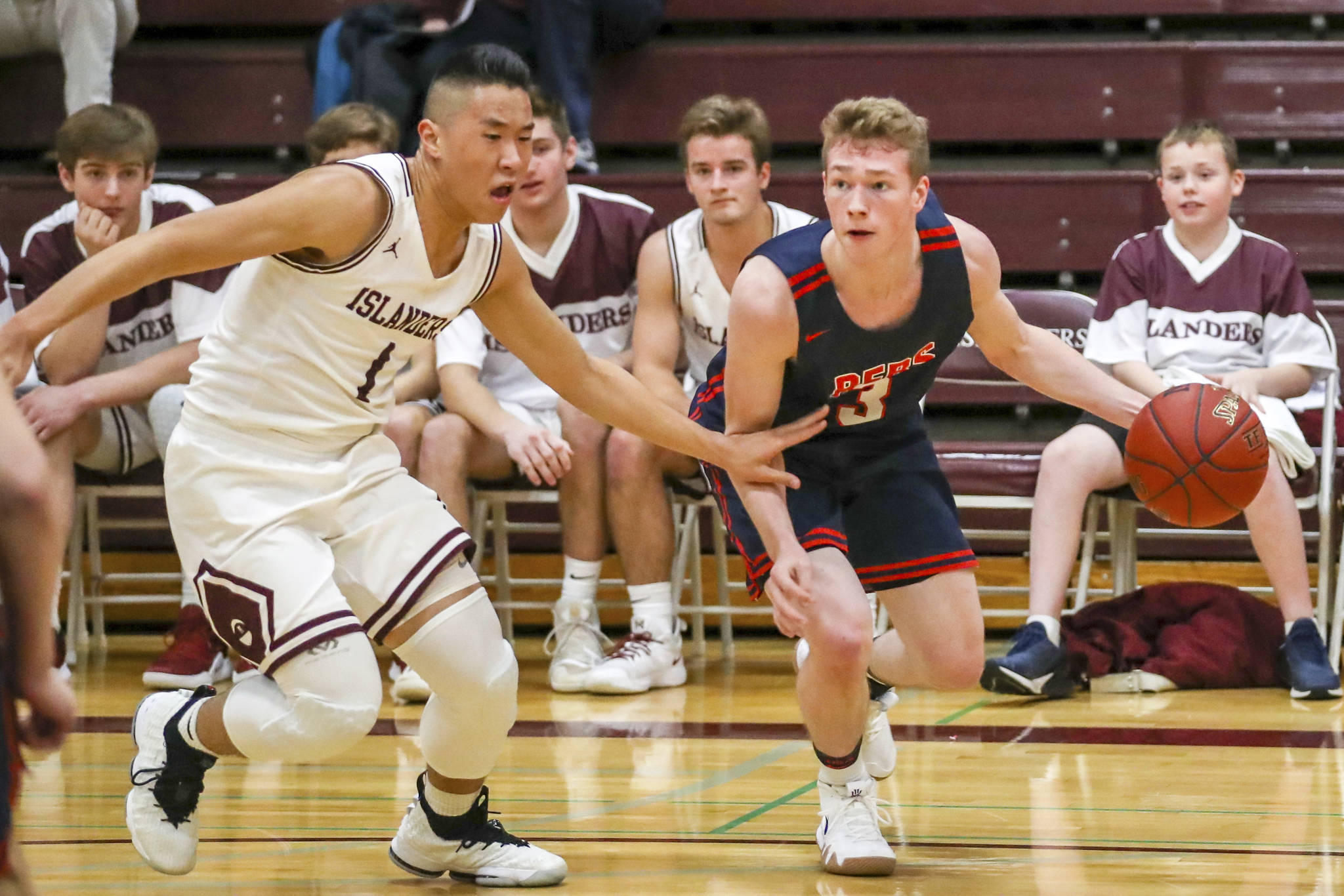 Mercer Island senior guard Will Lee, left, pressures Juanita junior Cooper Mcleod during the first half of play. Lee finished with 14 points against the Rebels. Photo courtesy of Rick Edelman/Rick Edelman Photography