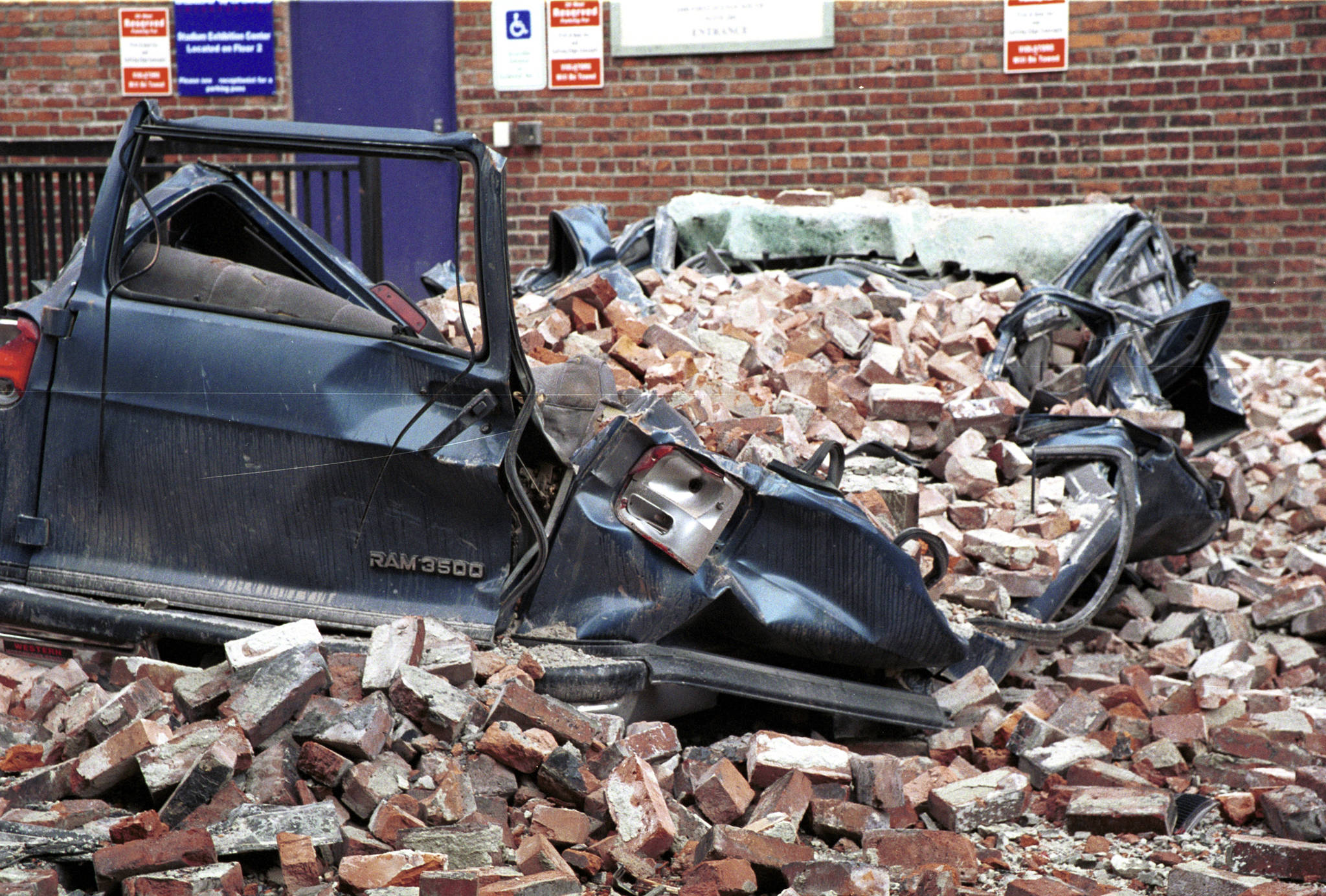 As seen on March 4, 2001, a large van was crushed by earthquake debris                                in a Seattle parking lot. FEMA News Photo by Kevin Galvin                                As seen on March 4, 2001, a large van was crushed by earthquake debris in a Seattle parking lot. FEMA News Photo by Kevin Galvin