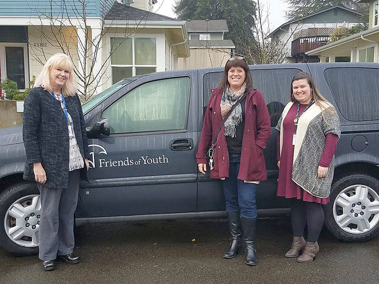 (L-R) Friends of Youth President and CEO Terry Potter and Senior Director of Homeless Youth Services Karina Wiggins receive van from Councilmember Balducci. Courtesy of King County.