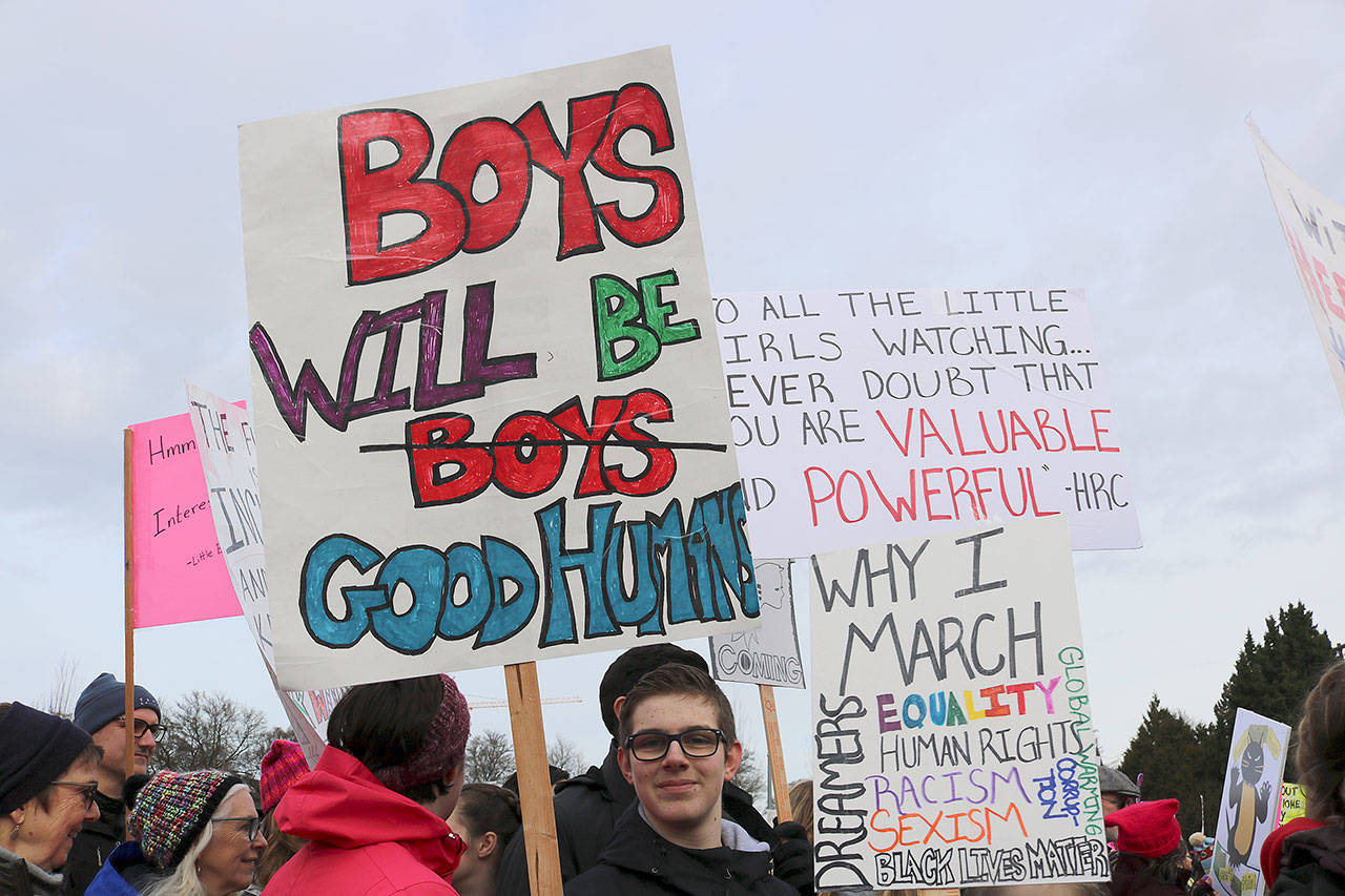 Young boy carries a sign that reads, “Boys will be good humans.” Stephanie Quiroz/staff photos
