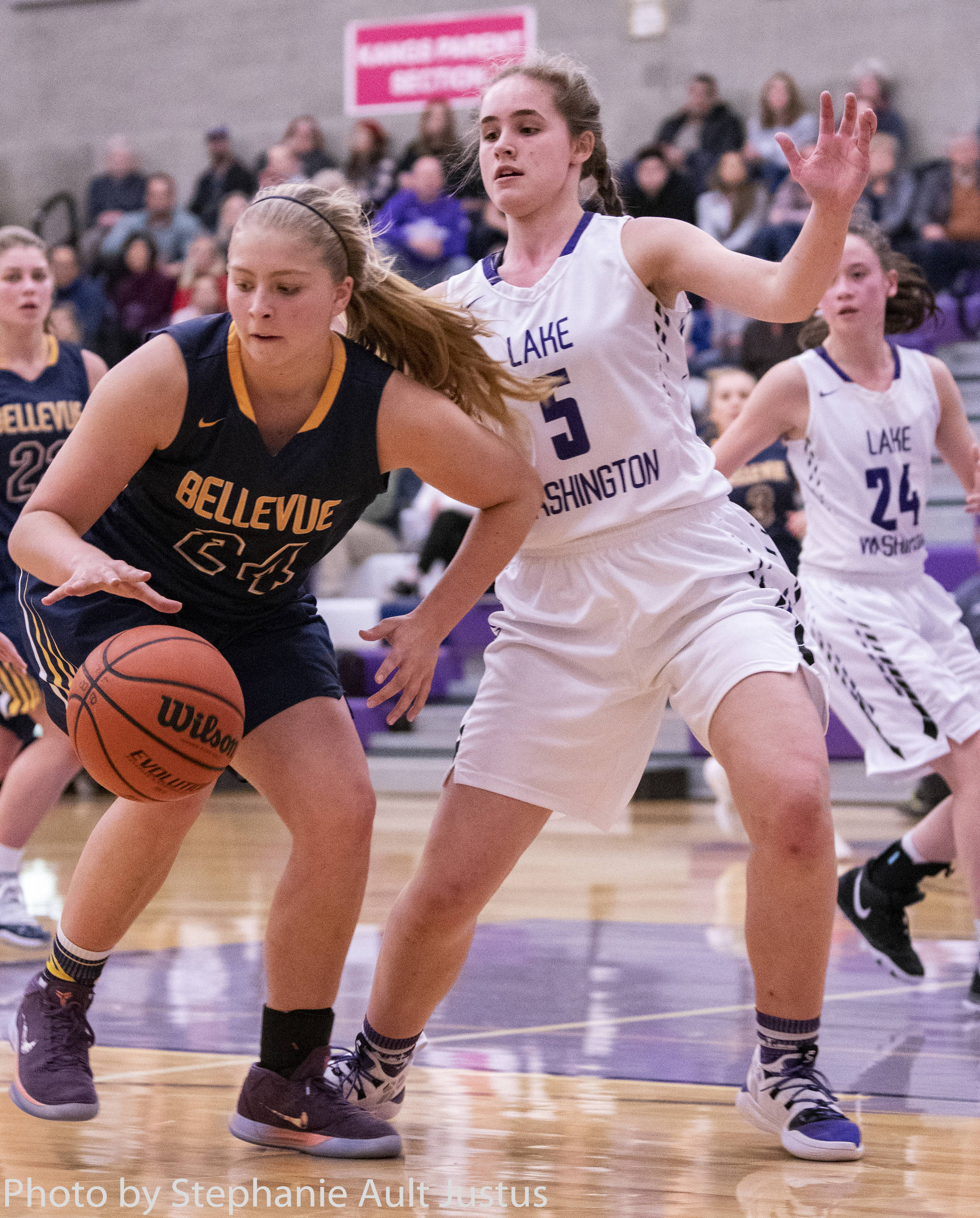 Bellevue Wolverines senior team captain Ali Jochums, left, gains possession of the ball in the paint while being covered by Lake Washington sophomore forward Brooke Filan. Lake Washington defeated Bellevue 57-37 on Jan. 23 in Kirkland. Photo courtesy of Stephanie Ault Justus