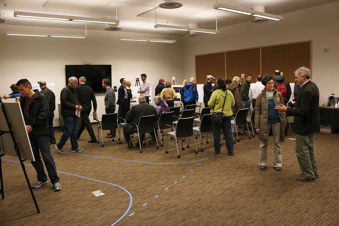 Kirkland residents discuss and review designs for a city project with city staff and contracted engineers at an open house in 2018 at the Kirkland Justice Center. The 124th project will host a similar open house on Feb. 12. Kailan Manandic/staff photo