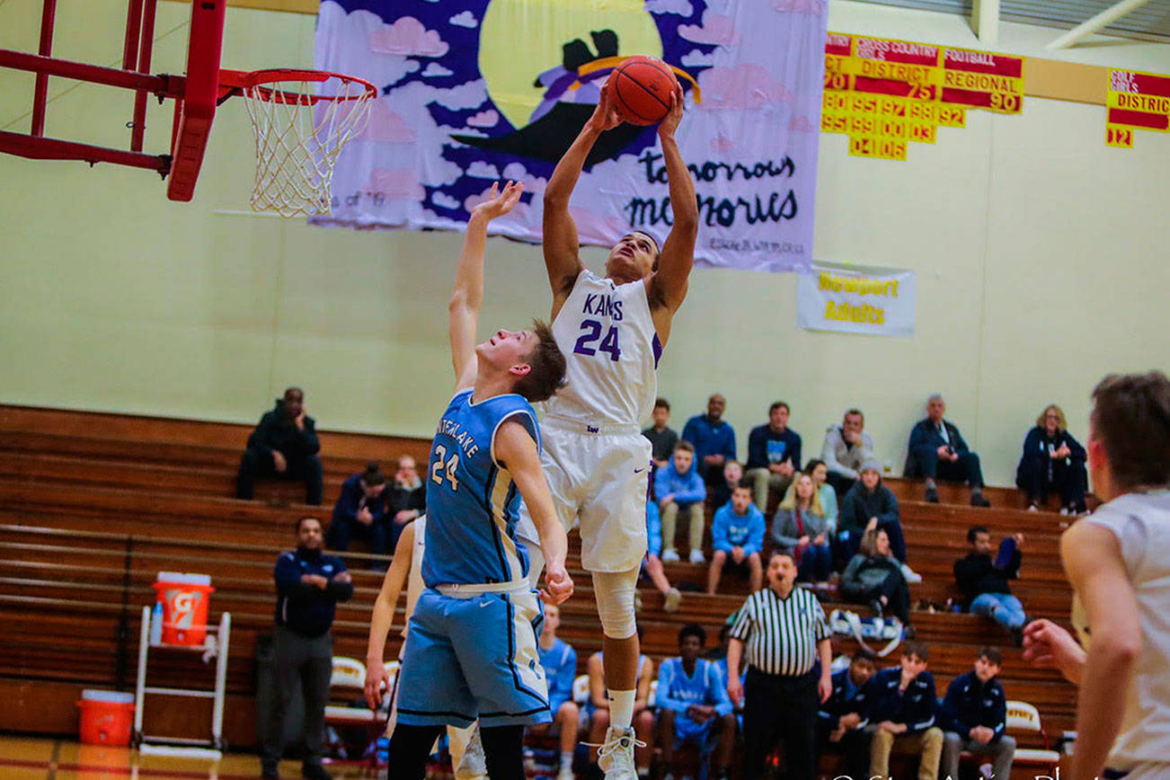 Lake Washington Kangaroos senior Torin Montgomery, right, leaps for a rebound against the Interlake Saints in a loser-out playoff game on Feb. 6 at Newport High School in Factoria. Interlake defeated Lake Washington 51-50. Photo courtesy of Don Borin/Stop Action Photography