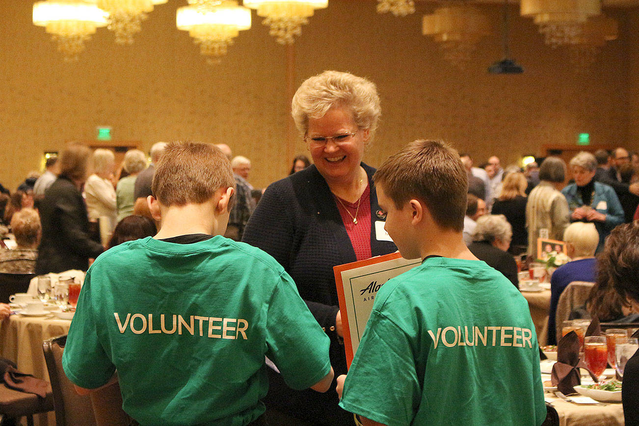 Suzanne Maxon purchases raffle tickets from two Friends of Youth volunteers at the Celebration of Youth event on March 1. Madison Miller/staff photo.