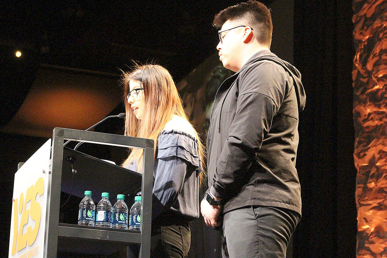Rosa and Erik, whose last names have been withheld share their experiences being a part of Youth Eastside Services (YES) Latino H.E.A.T. student-leadership program at the Invest in Youth Breakfast on March 20. Madison Miller/staff photo