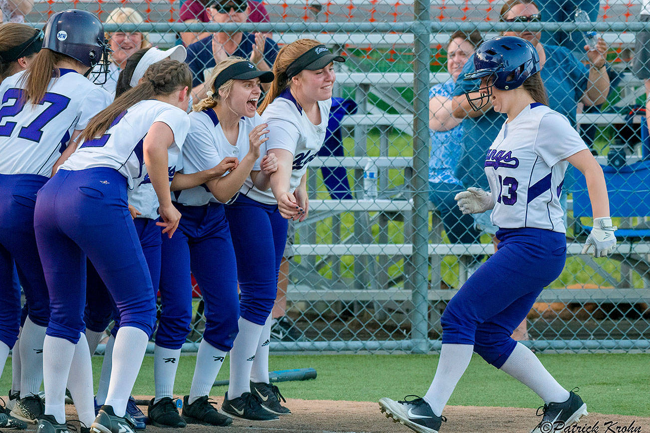 Lake Washington players mob sophomore Maddie Miller after she connected on a two-run home run in the top of the sixth inning. Lake Washington defeated Bellevue, 12-5, in the 3A KingCo tournament championship game on May 10 at Inglemoor High School in Kenmore. Photo courtesy of Patrick Krohn/Patrick Krohn Photography