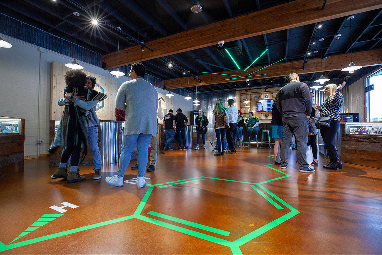 Courtesy photo                                Locals celebrate Kirkland’s newest pot shop, The Evergreen Market, which opened April 25.