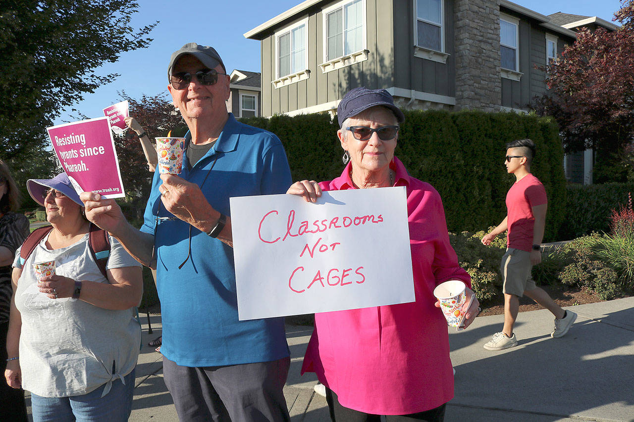 Kirkland residents Phil Sandifer (left) and Leah Kliger said they were happy to see so many Kirklanders at the Lights for Liberty Vigil on July 12. Stephanie Quiroz/staff photo