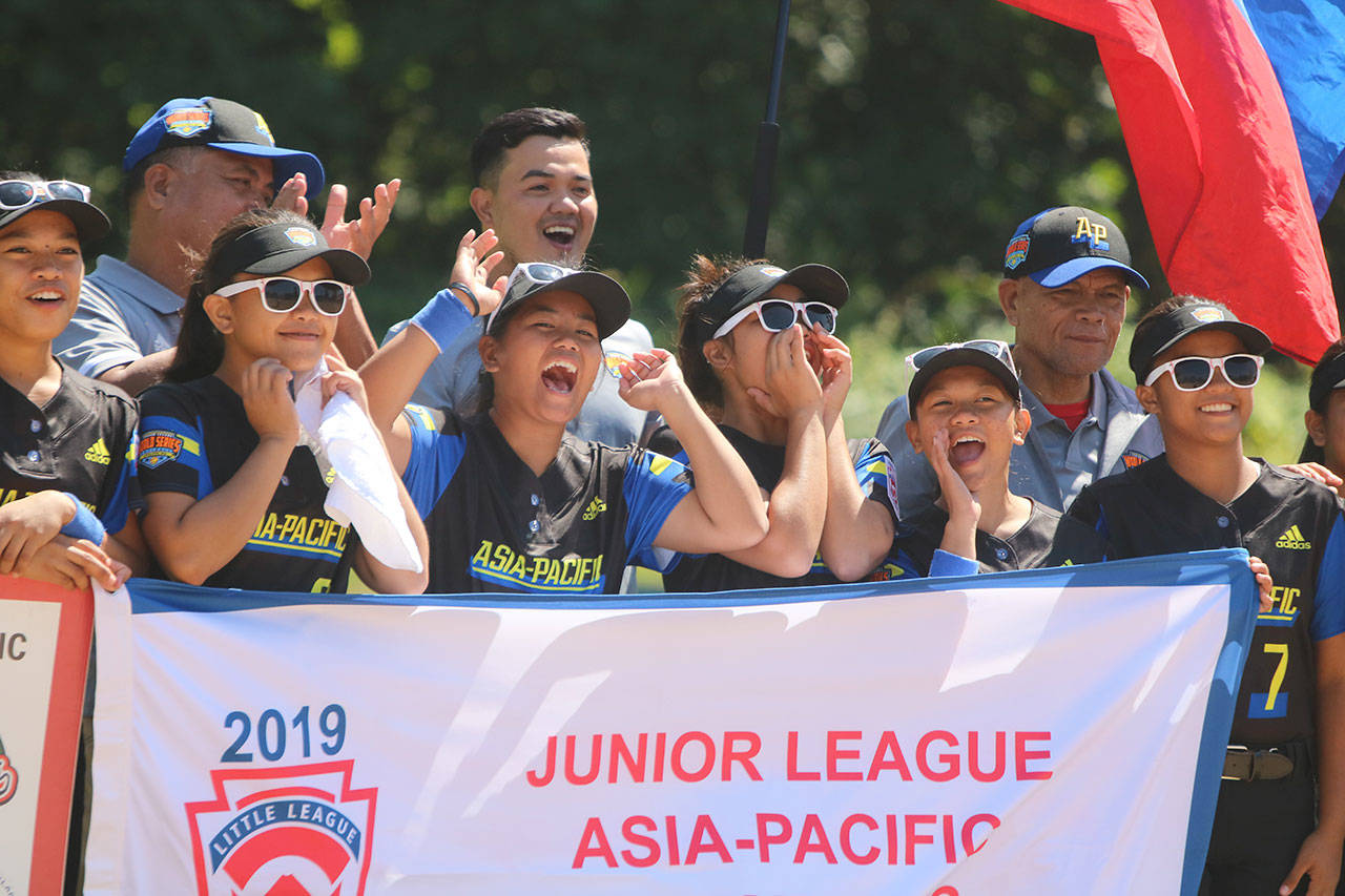 Asia-Pacific squad players from Bulacan Little League — Norzagaray, Philippines — enjoy the opening ceremony on July 28. Andy Nystrom/ staff photo