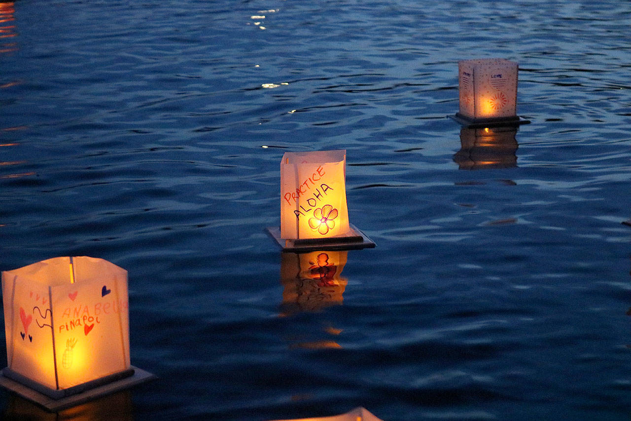 A water lantern that reads, “Practice Aloha” floats away on Juanita Bay. Stephanie Quiroz/staff photo