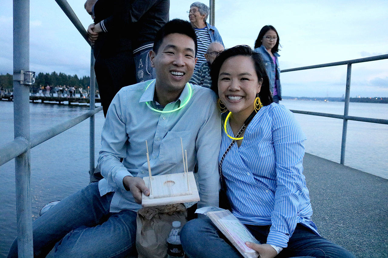 Ivan Lee and Ashley Yong from Lynwood build their lanterns at the 1,000 Lights Water Lantern Festival at Juanita Beach Park on Aug. 10. Stephanie Quiroz/staff photo