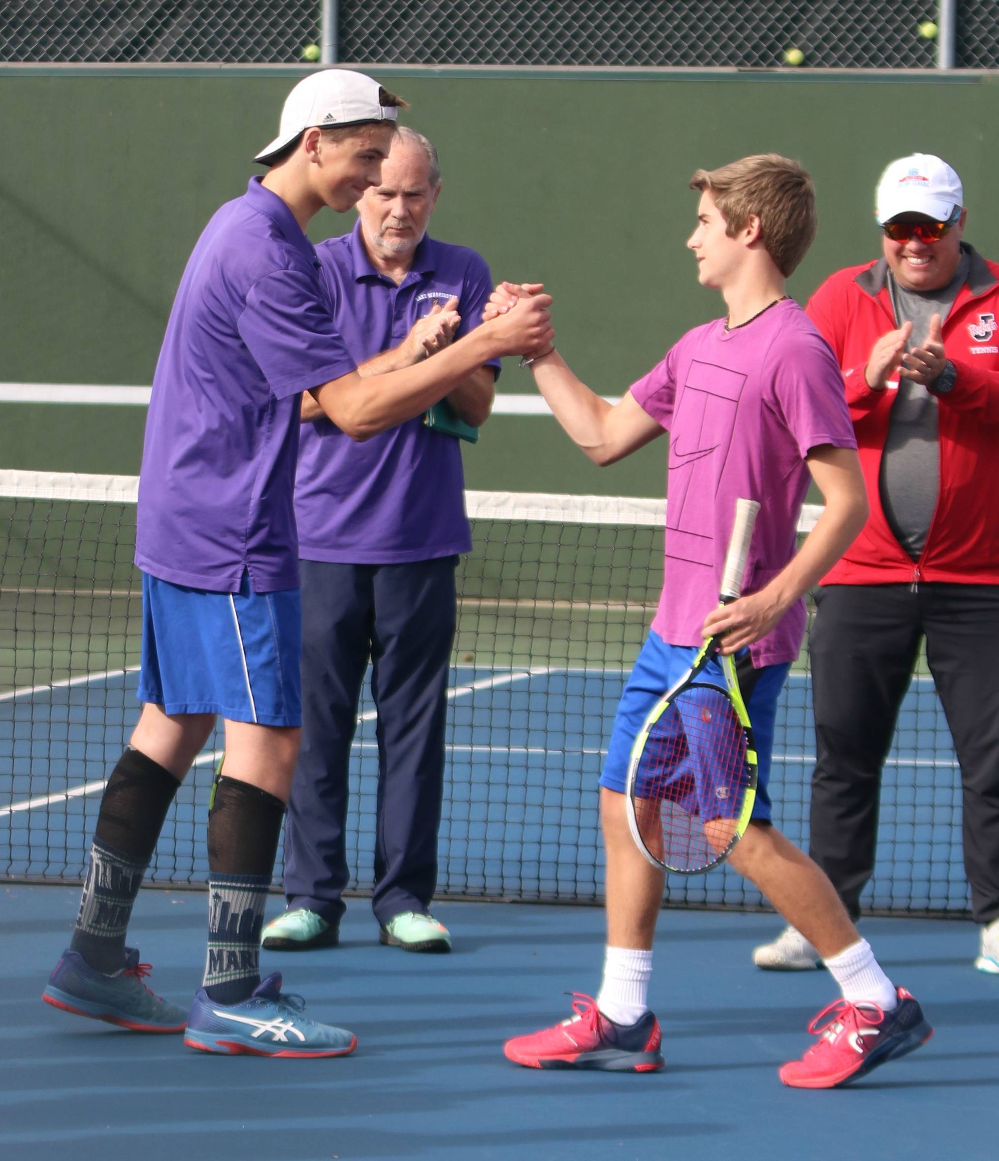 Sophomore No. 1 singles players Brett Pearson, left, and Dylan Bard greet each other before the Lake Washington-Juanita match on Sept. 26. Andy Nystrom/ staff photo