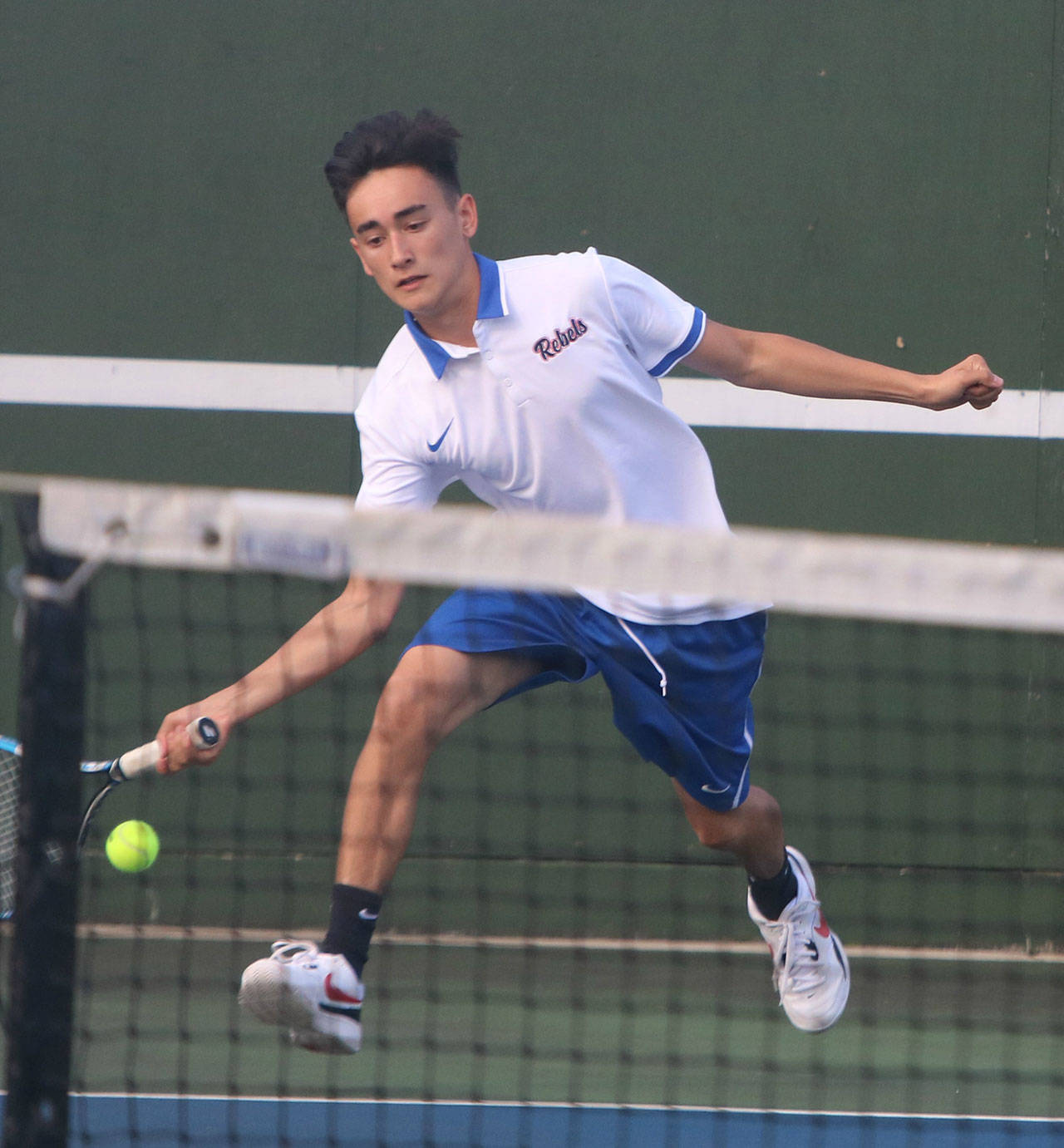 Juanita’s Jake Haas reaches for a ball in a No. 2 singles match against Lake Washington. Andy Nystrom/ staff photo