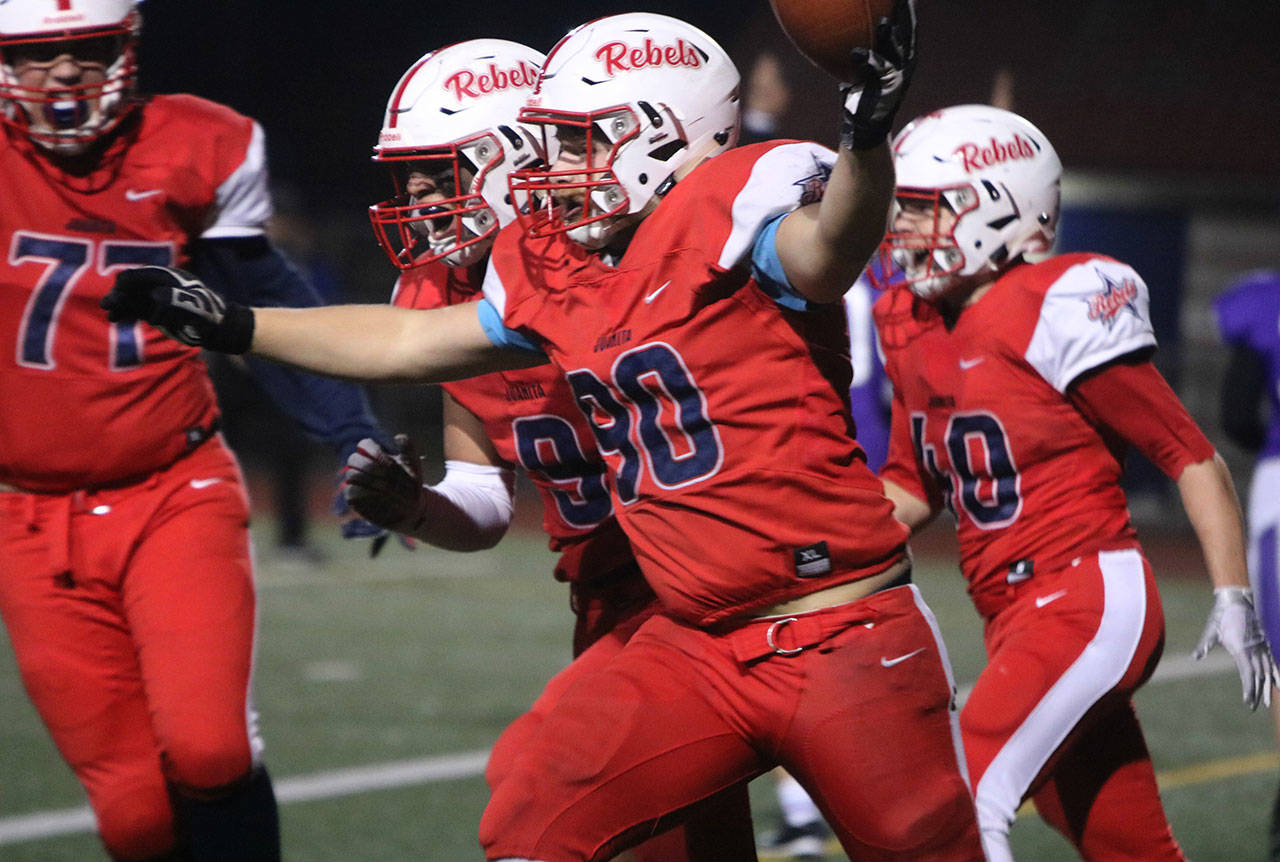 Juanita’s Keegan Eby (90) celebrates his fumble recovery for a touchdown. Andy Nystrom/ staff photo