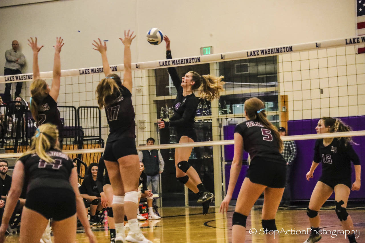 Lake Washington middle blocker Isabel Macpherson (6) hits the ball over the net during a league playoff game against Mercer Island on Nov. 7. Photo courtesy of Don Borin/Stop Action Photography