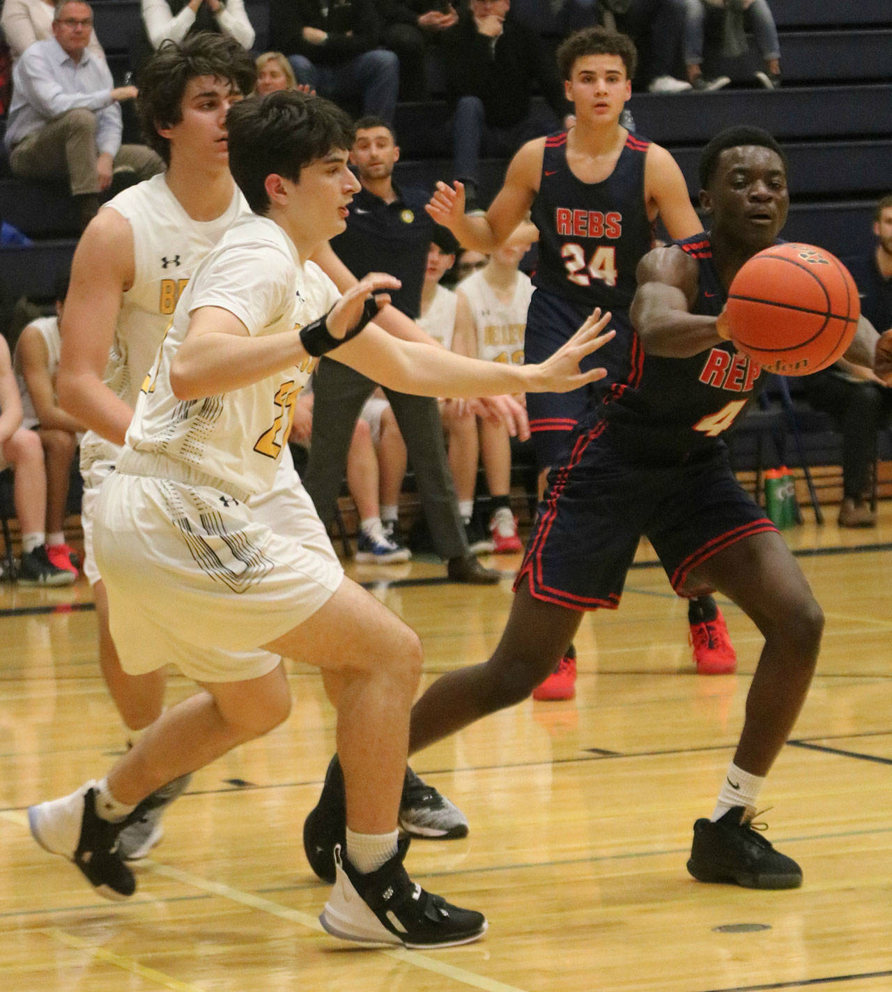 Juanita’s John Addo-Kufuor, right, reaches for the ball during a Dec. 10 matchup against Bellevue. Andy Nystrom/ staff photo