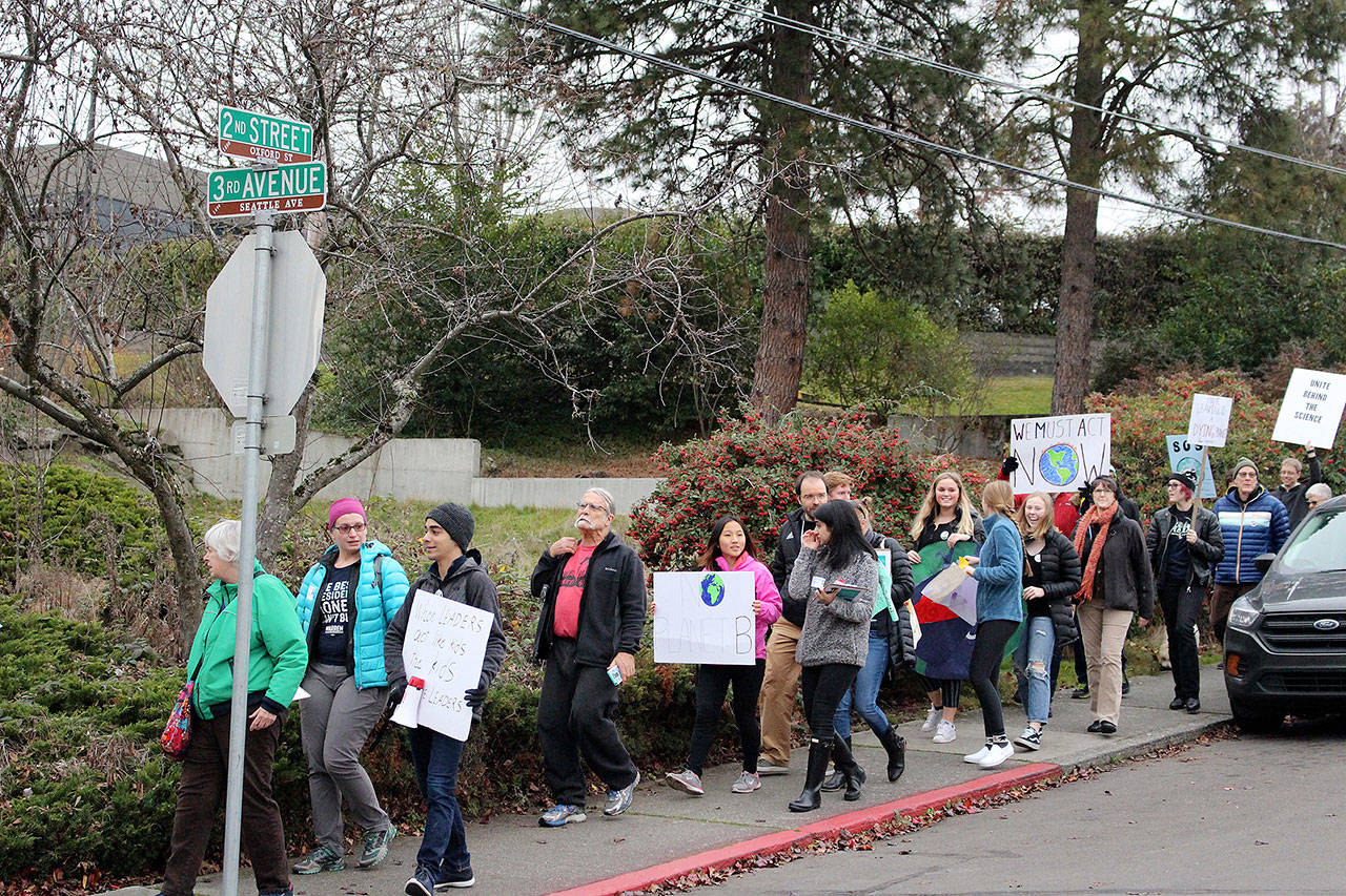 The protesters shout “Hey! Ho! Climate Change has got to go!” down 2nd Street in Kirkland. Madison Miller / staff photo