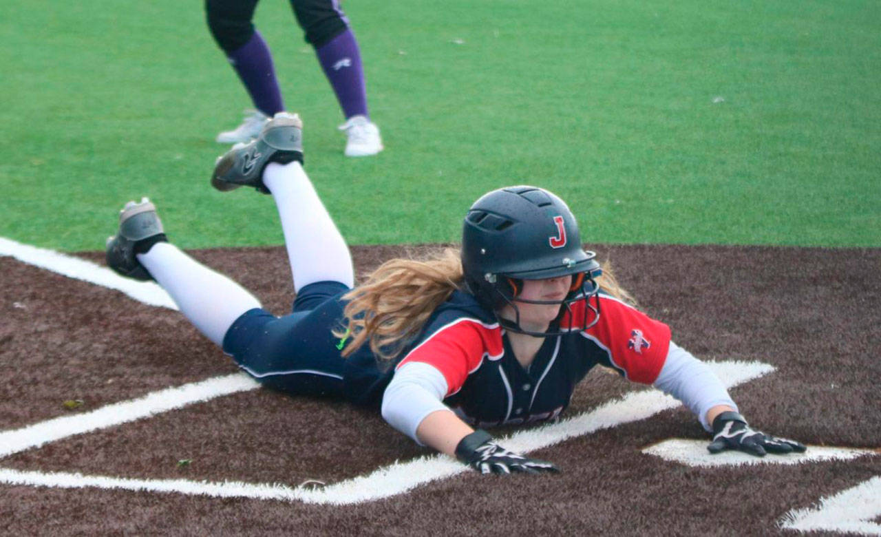 Juanita’s Abbie Reynolds slides in safe at home during the district tournament. Andy Nystrom/ staff photo