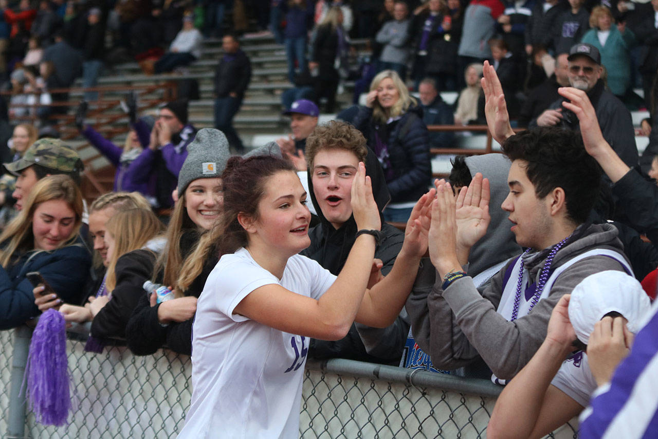 Lake Washington’s Alex Mueller slaps hands with friends after winning the 3A state girls soccer title. Andy Nystrom/ staff photo