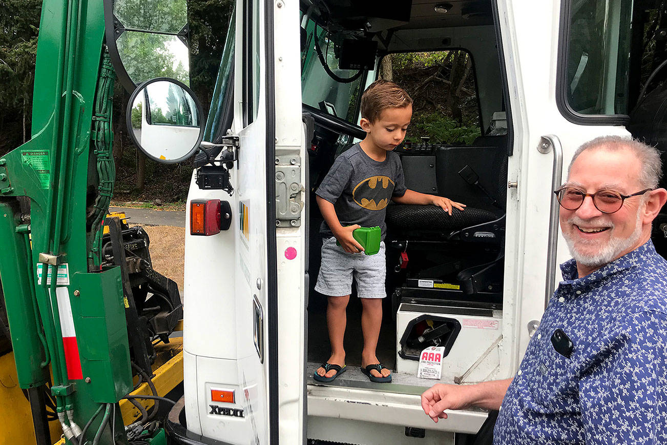 Mike Weinstein (right) with his grandson Owen at a take-your-children-to-work day event in Kirkland. Photo courtesy of Waste Management