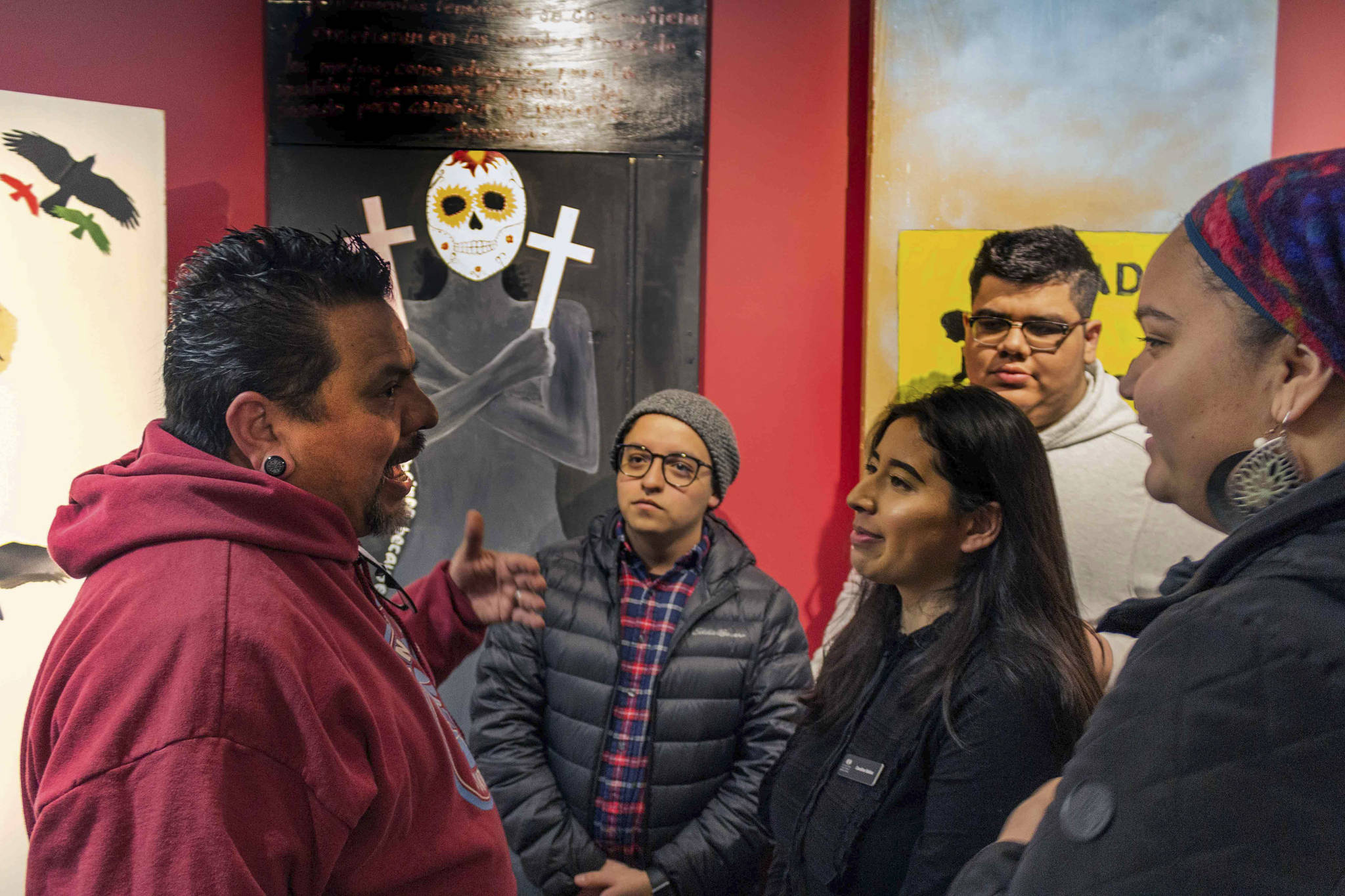 Claudio Pérez speaks with a group of students at the opening reception for the “Border Doors” exhibit at Centro Cultural Mexicano. Photo courtesy of Centro Cultural Mexicano