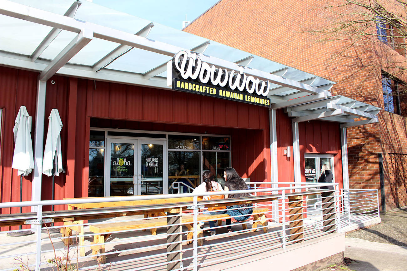 Two people enjoy conversation and food outside Wow Wow Hawaiian Lemonade in Kirkland, WA, on Feb. 27, 2020. Wow Wow’s final day was the 28, marking four years in Kirkland. Mitchell Atencio/Staff Photo