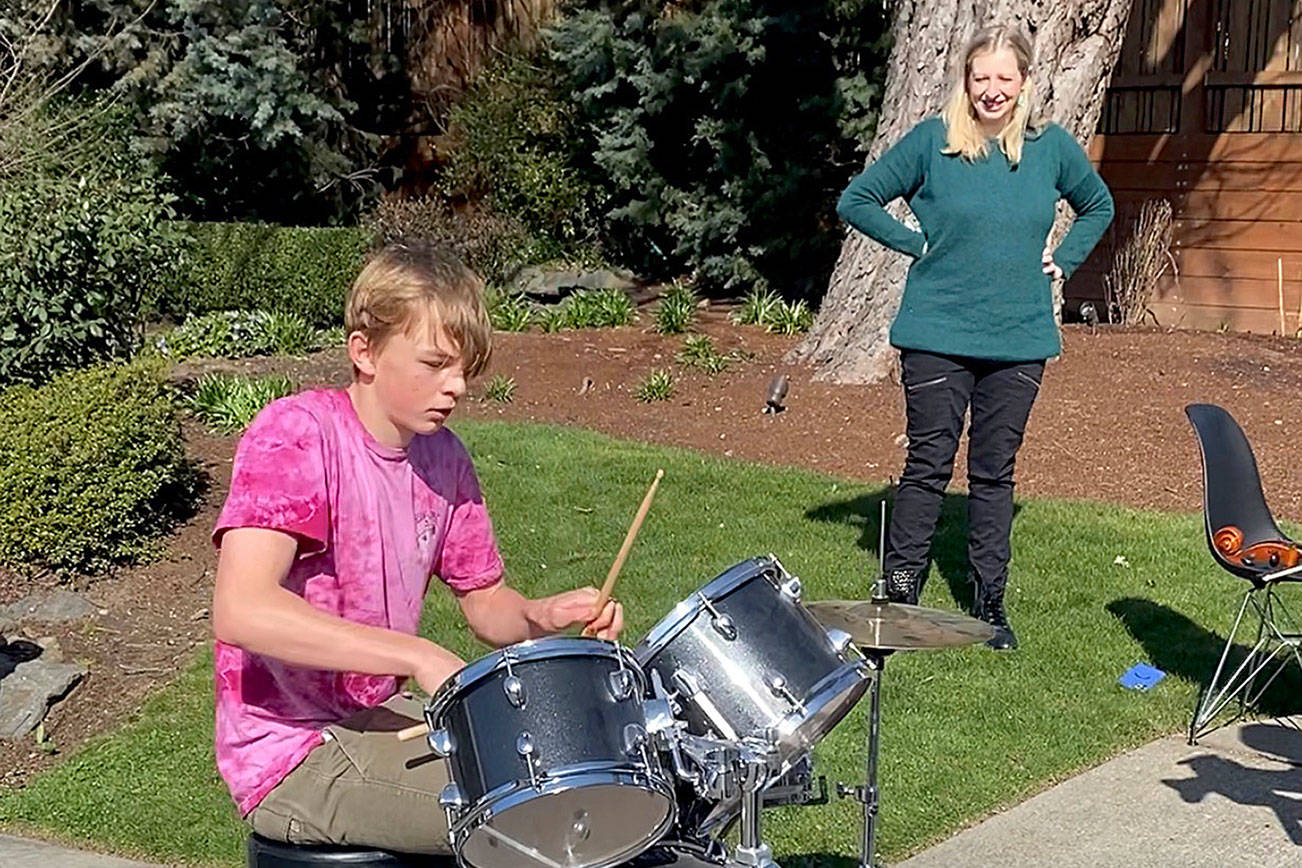 Photo courtesy of Meenakshi Sinha                                 From left, Kirkland residents Nick Davis and Silvia Bajardi play their instruments at a neighborhood music event March 15.