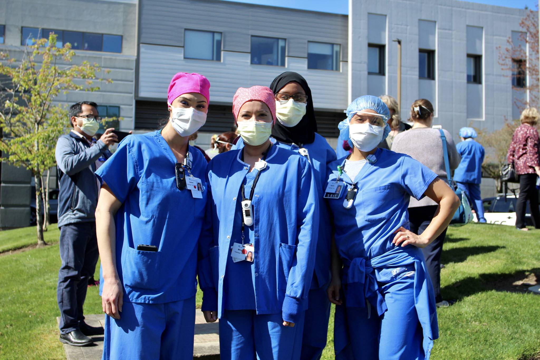 St. Francis Hospital employees pose for a photo, before laughing about smiling behind their masks. Olivia Sullivan/staff photo