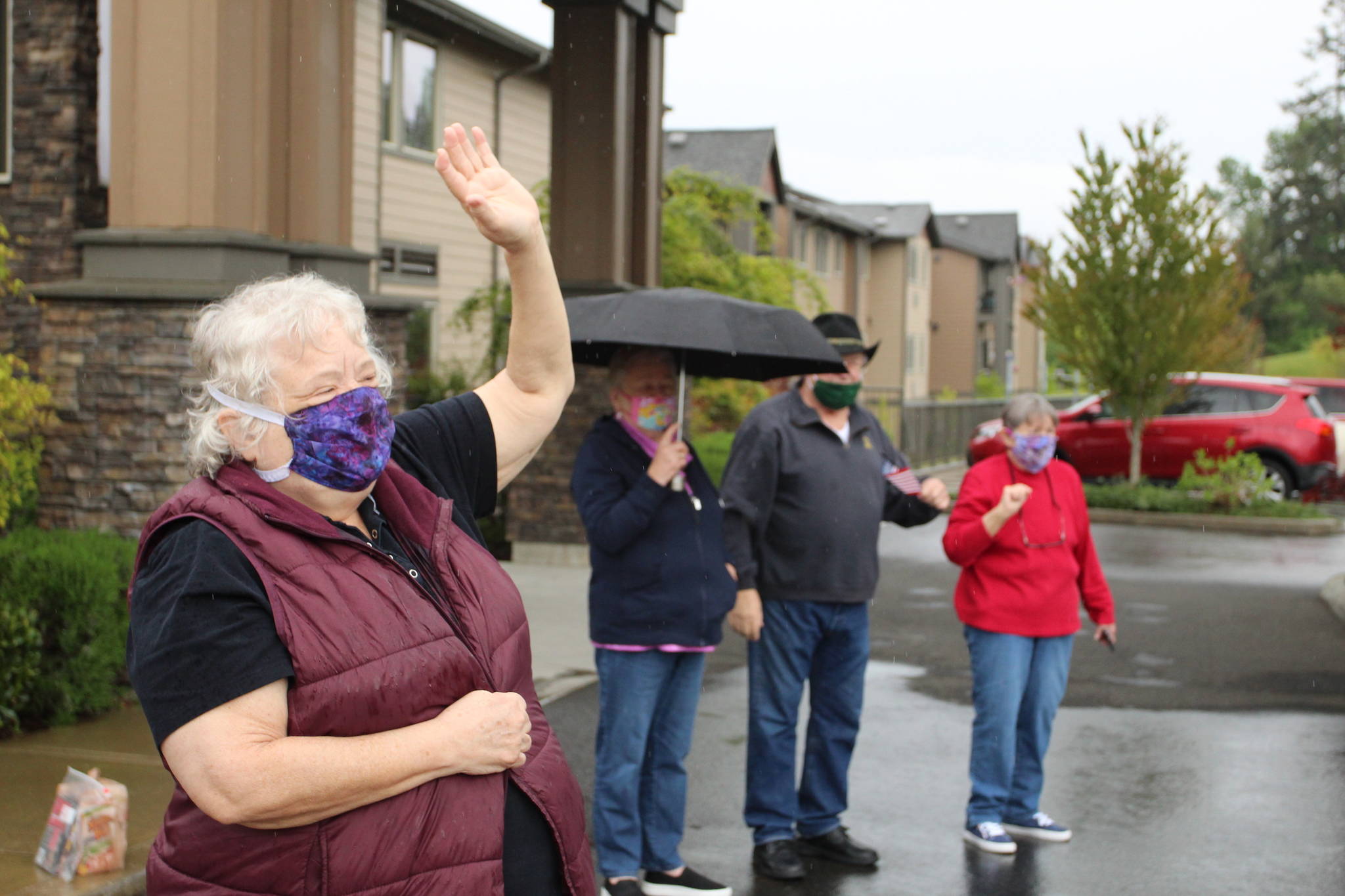 Doreen Davis, left in mask, waves at parade participants on May 2. Olivia Sullivan/staff photo