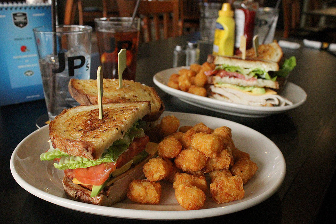 Local restaurants have had to adapt to new rules during the COVID pandemic. Pictured: JP’s Tavern in Federal Way’s turkey club sandwich with a side of tater tots. File photo