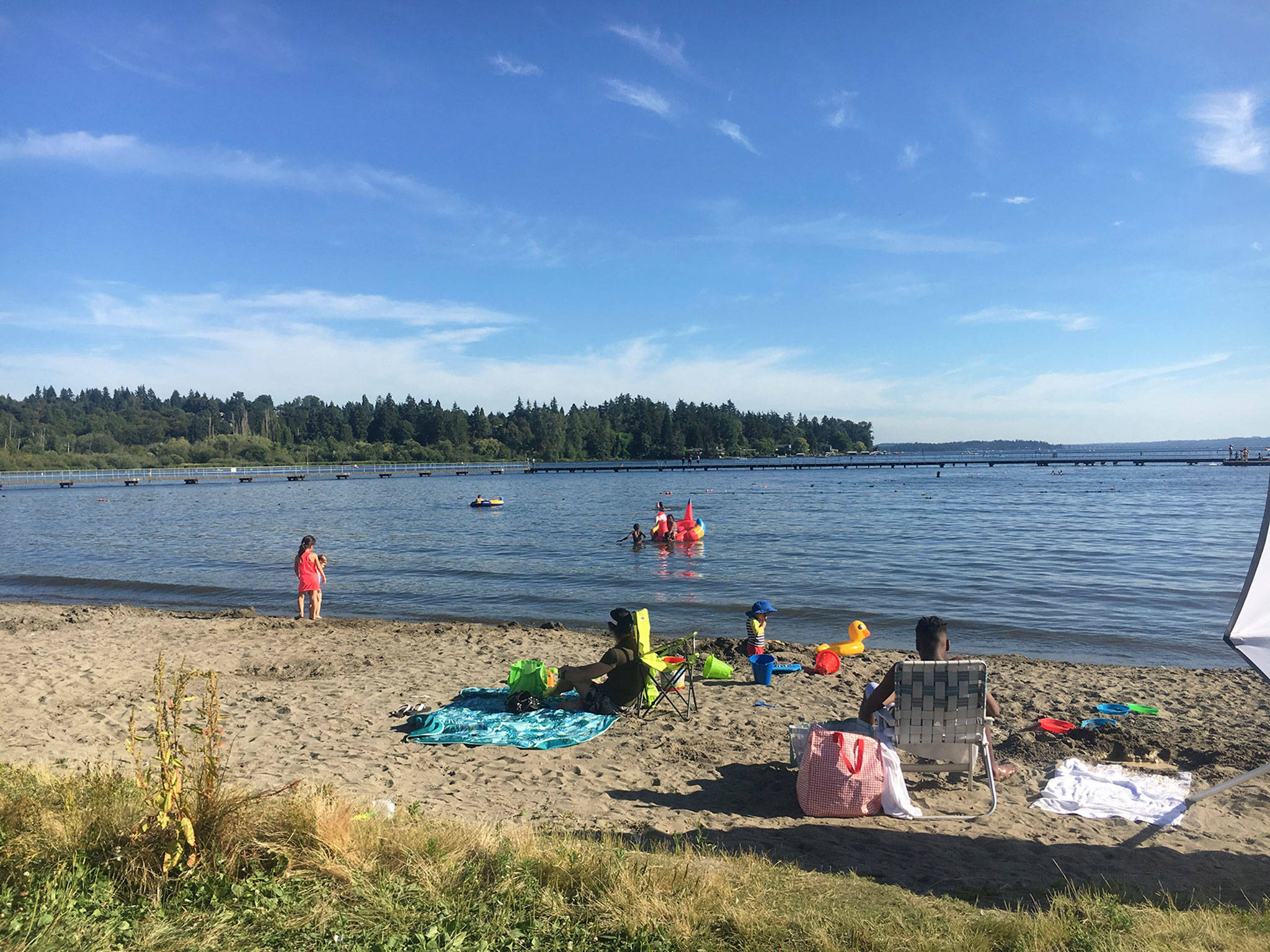Locals enjoy the water at Juanita Beach Park, where the Friday farmer’s market is located. Katie Metzger/staff photo